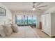 Main bedroom featuring a ceiling fan, tile flooring, and a scenic ocean view at 15000 Gulf Blvd # 901, Madeira Beach, FL 33708