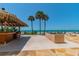 Outdoor poolside bar and grilling area with ocean views and access to the beach at 15000 Gulf Blvd # 901, Madeira Beach, FL 33708