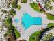 Aerial view of a swimming pool, hot tub, and lounge area surrounded by tropical landscaping at 15000 Gulf Blvd # 901, Madeira Beach, FL 33708
