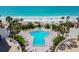 Swimming pool and hot tub area with poolside seating, palm trees, and beach view at 15000 Gulf Blvd # 901, Madeira Beach, FL 33708
