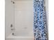 Bathroom featuring a combined shower and tub with white tile and patterned curtain at 17592 Nectar Flume Dr, Land O Lakes, FL 34638