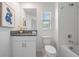 Bright bathroom featuring bathtub/shower combo and granite-topped vanity at 17592 Nectar Flume Dr, Land O Lakes, FL 34638