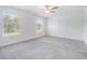 Sunlit bedroom with a ceiling fan and large windows offering a view of the outdoors at 17592 Nectar Flume Dr, Land O Lakes, FL 34638
