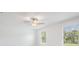 Bright bedroom featuring large windows, a ceiling fan, and neutral walls at 17592 Nectar Flume Dr, Land O Lakes, FL 34638