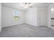 Bright bedroom with neutral carpet, ceiling fan, and view into the bath at 17592 Nectar Flume Dr, Land O Lakes, FL 34638