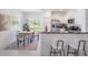 Bright dining area with modern furnishings, a large window, and an open flow to the contemporary kitchen at 17592 Nectar Flume Dr, Land O Lakes, FL 34638
