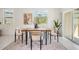 Airy dining space boasting a modern table, natural light, and a seamless connection to the outdoor area at 17592 Nectar Flume Dr, Land O Lakes, FL 34638