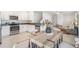 A bright, open kitchen with white cabinets, stainless steel appliances, granite countertops, and a dining area at 17592 Nectar Flume Dr, Land O Lakes, FL 34638