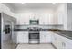 Well-lit kitchen with stainless steel appliances, granite countertops, and ample white cabinetry at 17592 Nectar Flume Dr, Land O Lakes, FL 34638