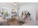 Inviting living space with contemporary furnishings, natural light, and an open layout leading to the dining area at 17592 Nectar Flume Dr, Land O Lakes, FL 34638