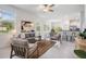 Open-concept living room with white walls, tile floors, ample seating, and a glimpse into the modern kitchen at 17592 Nectar Flume Dr, Land O Lakes, FL 34638