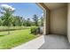 View from the patio overlooking the grassy backyard and serene pond at 17592 Nectar Flume Dr, Land O Lakes, FL 34638