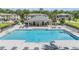 Community pool surrounded by lounge chairs with a covered pavilion at the far end at 17592 Nectar Flume Dr, Land O Lakes, FL 34638