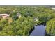 Aerial view of a lakefront property with lush greenery and a dock extending into the tranquil lake at 18324 Jorene Rd, Odessa, FL 33556