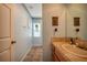 Bathroom with stylish decorations, tile flooring, and a large mirror above the wooden cabinet sink at 18324 Jorene Rd, Odessa, FL 33556