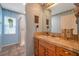 Stylish bathroom featuring a tiled vanity, framed mirror, and a walk-in shower at 18324 Jorene Rd, Odessa, FL 33556
