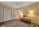 Neutral bedroom with a ceiling fan, closet, and a wooden bench at 18324 Jorene Rd, Odessa, FL 33556