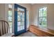 Bright entryway featuring a blue door with sidelights, tile floor, and a wooden bench at 18324 Jorene Rd, Odessa, FL 33556
