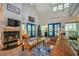 Bright living room featuring a fireplace, large windows, and stylish furniture arrangement at 18324 Jorene Rd, Odessa, FL 33556