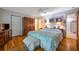 Comfortable main bedroom with wood floors, closet, ceiling fan, and natural light at 18324 Jorene Rd, Odessa, FL 33556