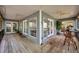 Expansive porch featuring ceiling fans, tongue and groove ceiling, and multiple seating areas at 18324 Jorene Rd, Odessa, FL 33556