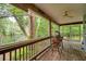 Relaxing screened porch with wooden floors and a view of the serene river and lush trees at 18324 Jorene Rd, Odessa, FL 33556