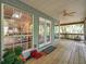 Cozy porch with views of the interior, ceiling fan, wood flooring, and access to the outdoors at 18324 Jorene Rd, Odessa, FL 33556