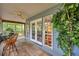 Charming porch with a ceiling fan, views of the lush greenery, and a cozy seating area at 18324 Jorene Rd, Odessa, FL 33556