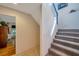 Hallway featuring staircase with carpeted steps and white banister, leading to the upper level of the home at 18324 Jorene Rd, Odessa, FL 33556