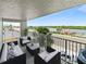 Relaxing balcony with comfortable outdoor seating and a picturesque view of the water at 18610 Gulf Blvd # 208, Indian Shores, FL 33785