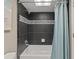 Updated bathroom featuring a tub with a modern tile surround and a light blue shower curtain at 18610 Gulf Blvd # 208, Indian Shores, FL 33785