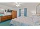 Comfortable bedroom featuring a dresser, wooden wardrobe, and a bright window with drapes at 18610 Gulf Blvd # 208, Indian Shores, FL 33785