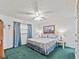 Cozy bedroom with a comfortable bed, bright windows with drapes and a ceiling fan at 18610 Gulf Blvd # 208, Indian Shores, FL 33785
