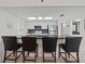 Bright kitchen features white cabinetry, stainless steel appliances, and a breakfast bar with seating for four at 18610 Gulf Blvd # 208, Indian Shores, FL 33785