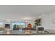 Open-concept kitchen island overlooks the living area with access to an outdoor view at 18610 Gulf Blvd # 208, Indian Shores, FL 33785