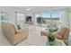 Open living room with tile flooring and a sliding glass door leading to a balcony at 18610 Gulf Blvd # 208, Indian Shores, FL 33785