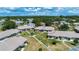 An aerial view of a villa featuring manicured lawns and mature trees at 1906 Canterbury Ln # 20, Sun City Center, FL 33573