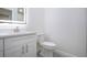 A bright bathroom offers a modern vanity, a large mirror, and a toilet, designed for a comfortable experience at 1906 Canterbury Ln # 20, Sun City Center, FL 33573
