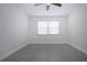 Bright bedroom featuring a ceiling fan, neutral walls, wood-look tile flooring, and a large window at 1906 Canterbury Ln # 20, Sun City Center, FL 33573