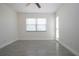 Bright bedroom featuring a ceiling fan, neutral walls, wood-look tile flooring, and a large window at 1906 Canterbury Ln # 20, Sun City Center, FL 33573