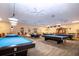 Billiard room with multiple pool tables, ceiling fans, and lighting at 1906 Canterbury Ln # 20, Sun City Center, FL 33573