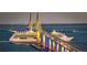 Cruise ship traveling under a bridge illuminated with yellow and blue lights at night at 1906 Canterbury Ln # 20, Sun City Center, FL 33573