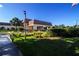 A well-maintained clubhouse with palm trees, offers a space for community gatherings at 1906 Canterbury Ln # 20, Sun City Center, FL 33573