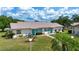 Attractive home with a well-manicured lawn, lush landscaping, and a welcoming walkway at 1906 Canterbury Ln # 20, Sun City Center, FL 33573