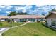 A beautiful home boasting a manicured lawn, tasteful landscaping, and an inviting walkway at 1906 Canterbury Ln # 20, Sun City Center, FL 33573