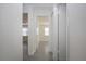 Hallway with multiple doors leading to bedrooms with neutral walls and wood-look tile flooring at 1906 Canterbury Ln # 20, Sun City Center, FL 33573