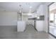 Bright kitchen features white cabinets, subway tile backsplash, stainless steel appliances, and an island at 1906 Canterbury Ln # 20, Sun City Center, FL 33573