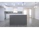 Bright kitchen features white cabinets, subway tile backsplash, stainless steel appliances, and an island at 1906 Canterbury Ln # 20, Sun City Center, FL 33573