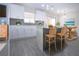 Modern kitchen features white cabinets, stainless steel appliances, and a breakfast bar with seating at 1906 Canterbury Ln # 20, Sun City Center, FL 33573