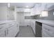 Modern kitchen island featuring white cabinets and drawers and white countertops at 1906 Canterbury Ln # 20, Sun City Center, FL 33573